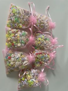 several bags filled with lots of different types of buttons and beads on top of each other