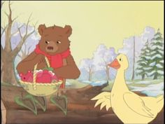 there is a bear that is holding a basket with eggs and a duck in front of it