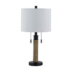 a table lamp with a white shade on it and a black base, sitting on a white background