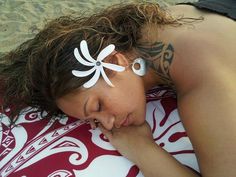 a woman laying on top of a red and white towel