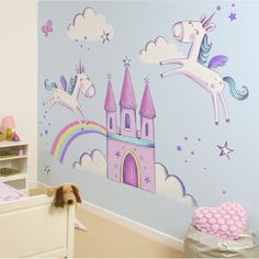 a child's bedroom decorated in pink and blue with unicorns on the wall