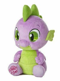 a purple and green stuffed animal with big eyes