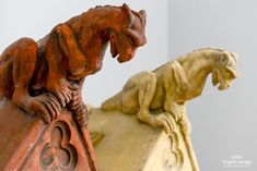 two carved wooden animals sitting on top of each other