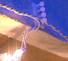 an electrical cord is plugged into the side of a building's roof at night