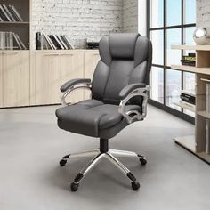 a black office chair sitting in front of a book shelf with books on the shelves