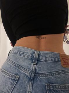 the back of a woman's stomach with her name tattooed on its lower part