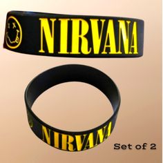 two wristbands that say nirvana and set of 2 in yellow lettering on black