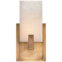 a wall light with a white glass shade on the top and gold metal frame around it