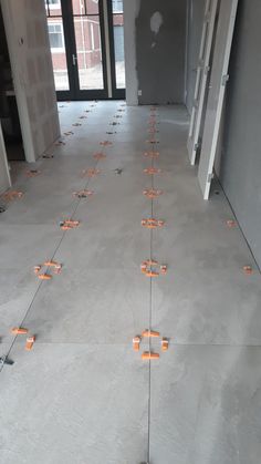 an empty room with orange candles on the floor