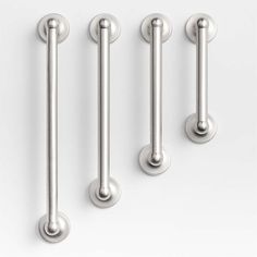 four stainless steel handles and knobs on a white background