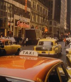 taxi cabs and taxis on a busy city street