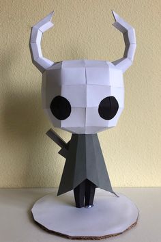 an origami paper sculpture of a horned man