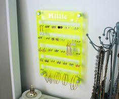 a yellow jewelry rack with earrings hanging on it