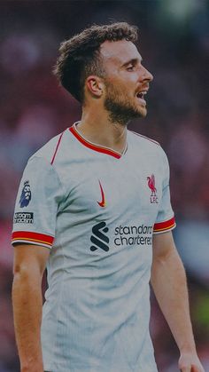 a man with a beard wearing a soccer uniform