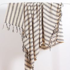 a white and black striped towel hanging from a hook