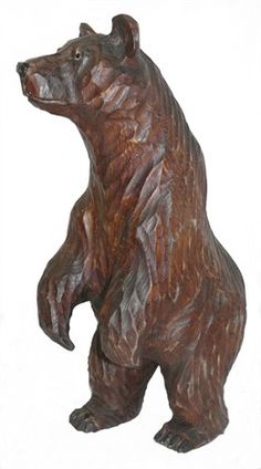 a brown bear statue sitting on its hind legs