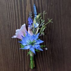 some blue and pink flowers on a wooden surface