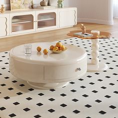 a living room with white furniture and black and white flooring