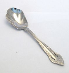 a silver spoon sitting on top of a white table