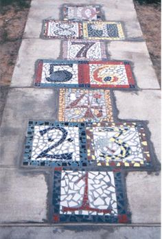 the sidewalk is decorated with different designs and numbers on it, along with other decorative items