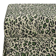 an animal print bed spread with green and black spots