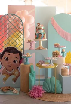 a table filled with cakes and desserts next to a wall covered in paper decorations