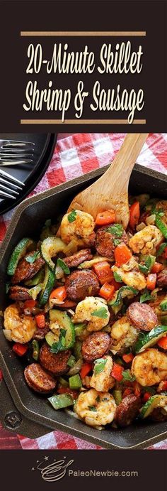 a skillet filled with shrimp and sausage on top of a checkered table cloth