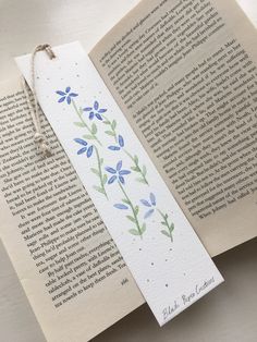 Delicately hand painted bookmark Blue floral detail  Using watercolour paint on watercolour paper Finished with hand tied string Perfect for gifts Book Marks Water Colour, Funky Bookmarks, Watercolour Bookmarks Easy, Bookmark Diy Ideas, Easy Watercolor Bookmarks, Cute Bookmarks Handmade, Bookmark Crochet Tutorial, Made Bookmark, Painting Bookmarks