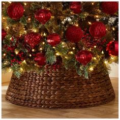 a christmas tree with red ornaments in a basket