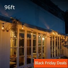 a black friday sale is on the outside of a building with lights strung from it