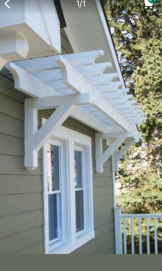 an outside view of a house with white trim