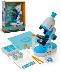 a toy microscope and its contents on a white surface next to a box with blue labels