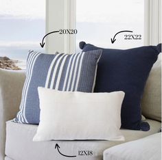 the measurements of pillows on a couch in front of a window with an ocean view