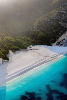 an aerial view of the blue water and mountains