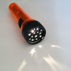 an orange and black object with white stars on it