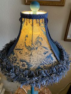 a blue and yellow lamp shade sitting on top of a table