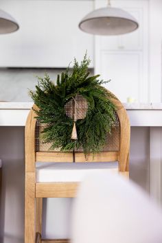 a wooden chair with a wreath on it