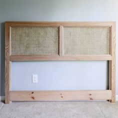 the headboard is made out of wood and has wicker paneling on it