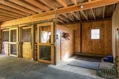 an empty room with wooden walls and doors