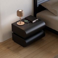 a nightstand with a phone on it next to a bed