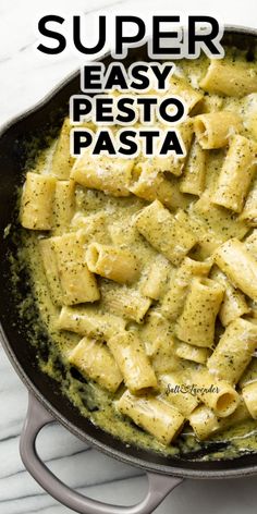 a skillet filled with pasta covered in pesto