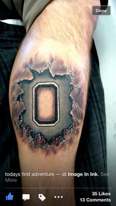 a man's arm with a hole in the middle and an o on it