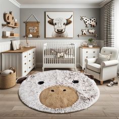 a baby's room with a cow rug on the floor and pictures above it