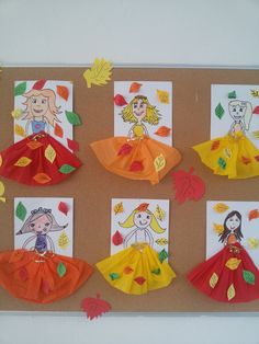 a bulletin board with paper dolls and fall leaves