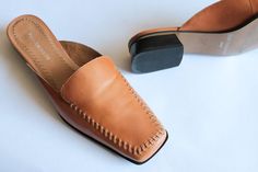 Beautiful pair of Enzo  Angiolini Italian leather slides with stitch detail. 8 and a 1/2. M is the listed size with little signs of wear to the bottom soul. Interior is clean and overall very good condition. Slight scuffing to small sections of leather. See Photos for details. Calf Leather Slip-on Slippers With Branded Insole, Leather Slip-on Slides With Stitched Sole, Brown Leather Sole Slip-on Sandals, Brown Leather Sole Slip-on Mules, Brown Slip-on Mules With Buckle Closure, Faux Fur Hat, Royal Colors, Tapestry Bag, Slides Sandals