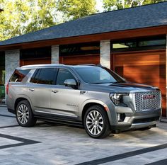 a silver suv parked in front of a garage