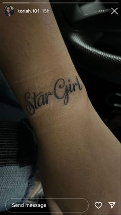 a person with a tattoo on their arm that says star girl in cursive writing