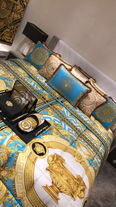 a bed with gold and blue designs on it