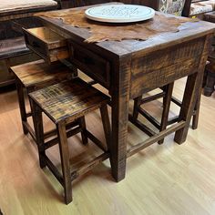 a wooden table with two stools and a plate on top