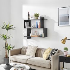 a living room filled with furniture and lots of shelves on the wall above it's coffee table